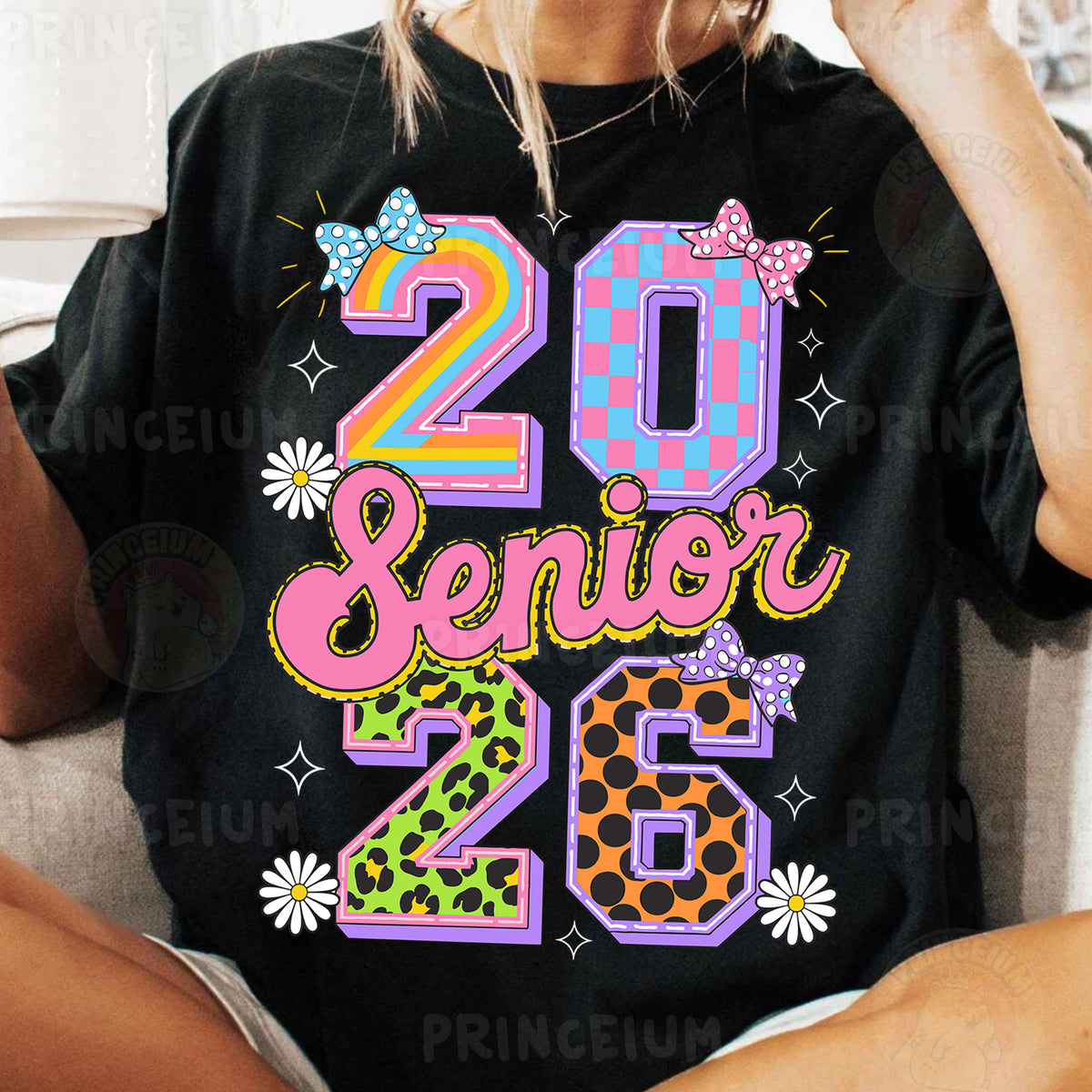 a woman sitting on a couch wearing a t - shirt with the number twenty twenty