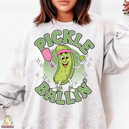 a woman wearing a pickle ballin sweatshirt