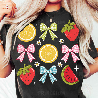 a woman wearing a black tshirt with fruit and bows on it
