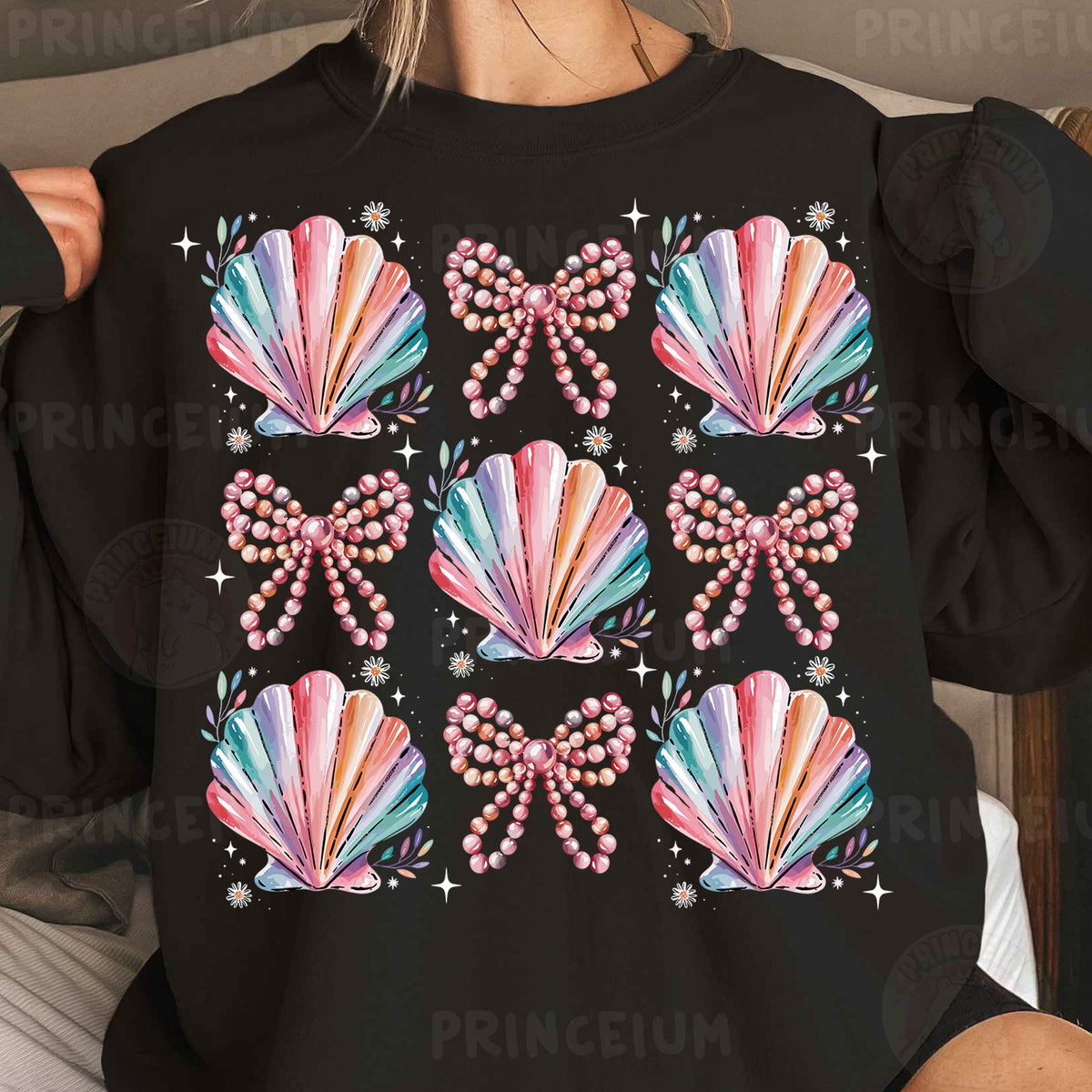 a woman wearing a black shirt with colorful seashells on it
