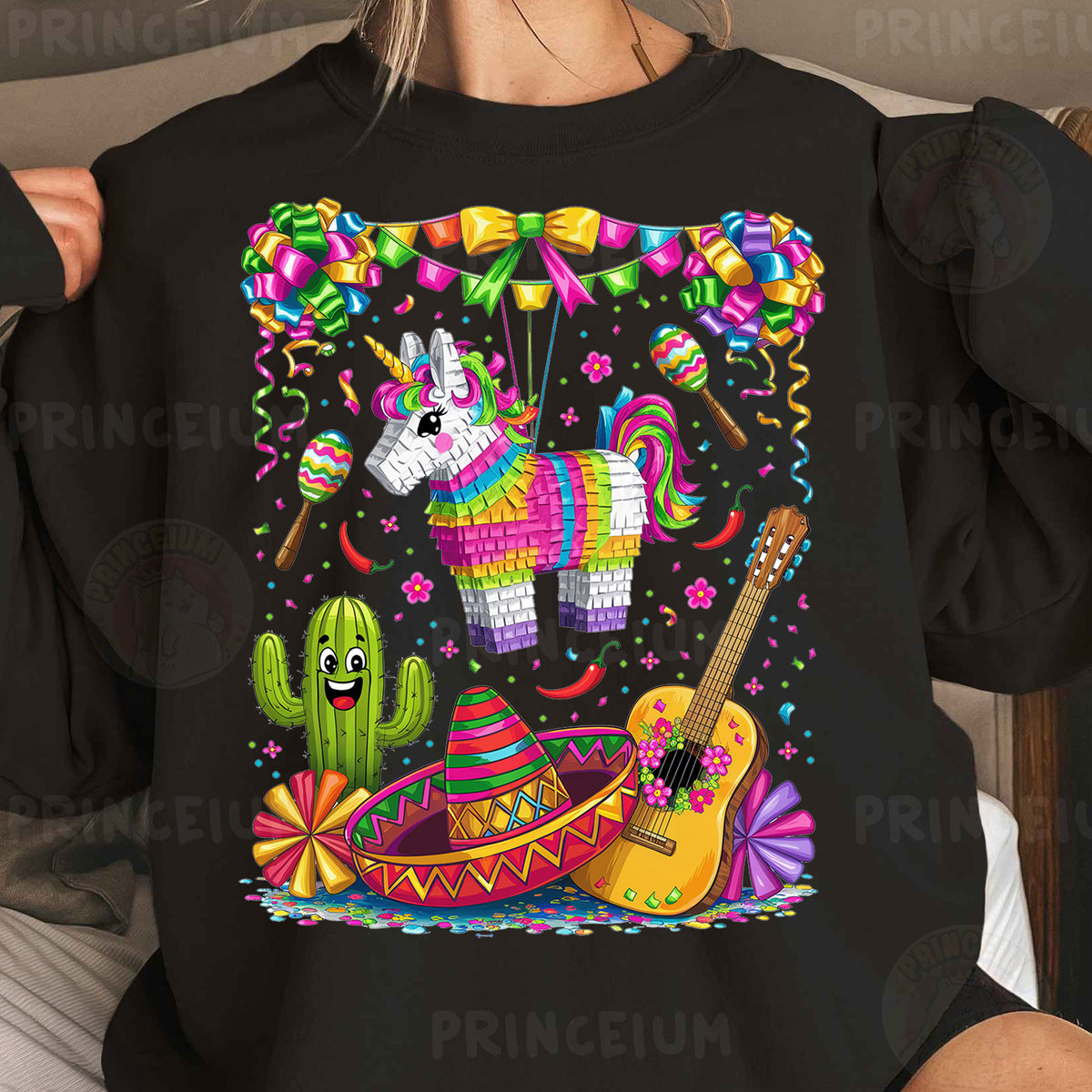 a woman wearing a black shirt with an image of a unicorn and a guitar