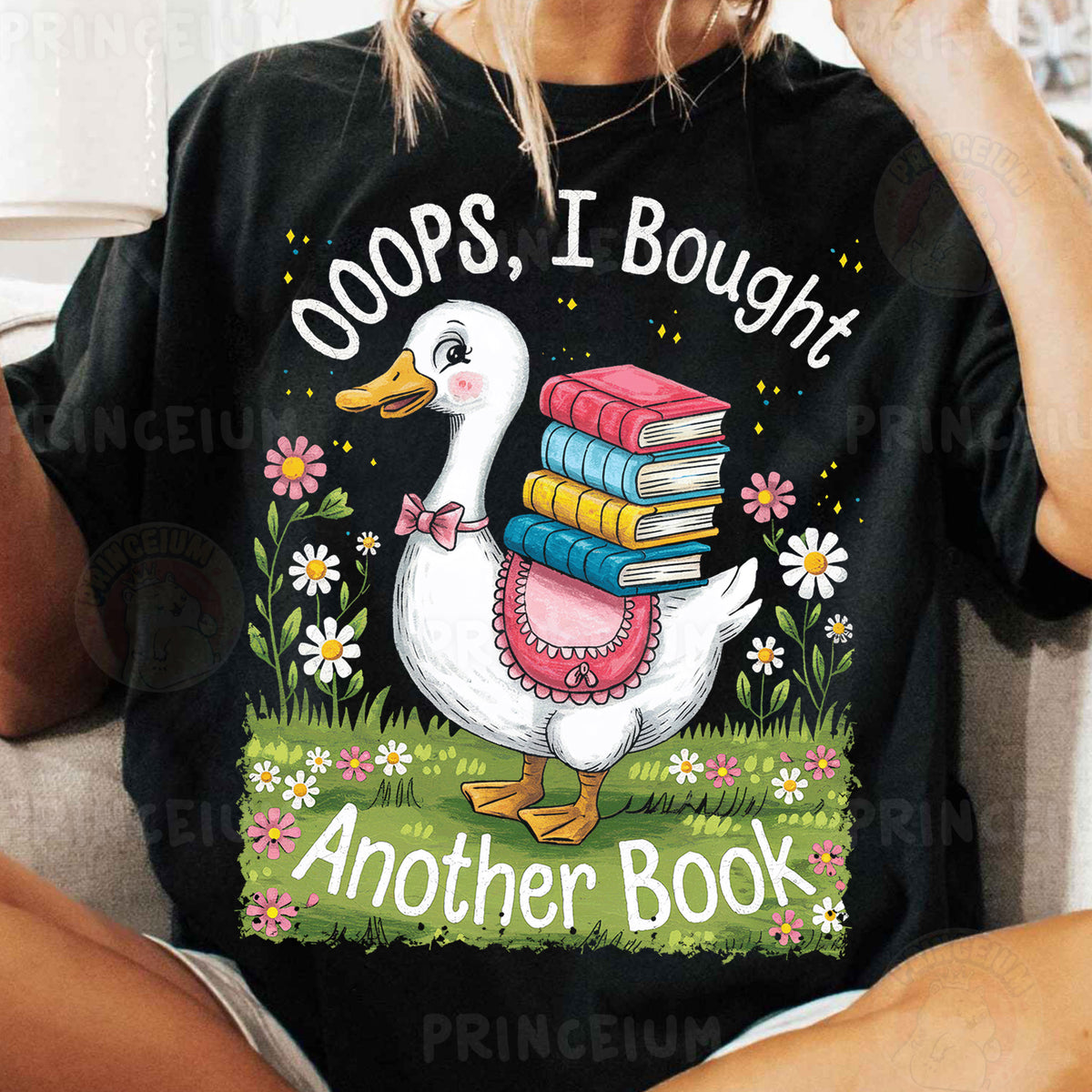 a woman sitting on a couch holding a stack of books
