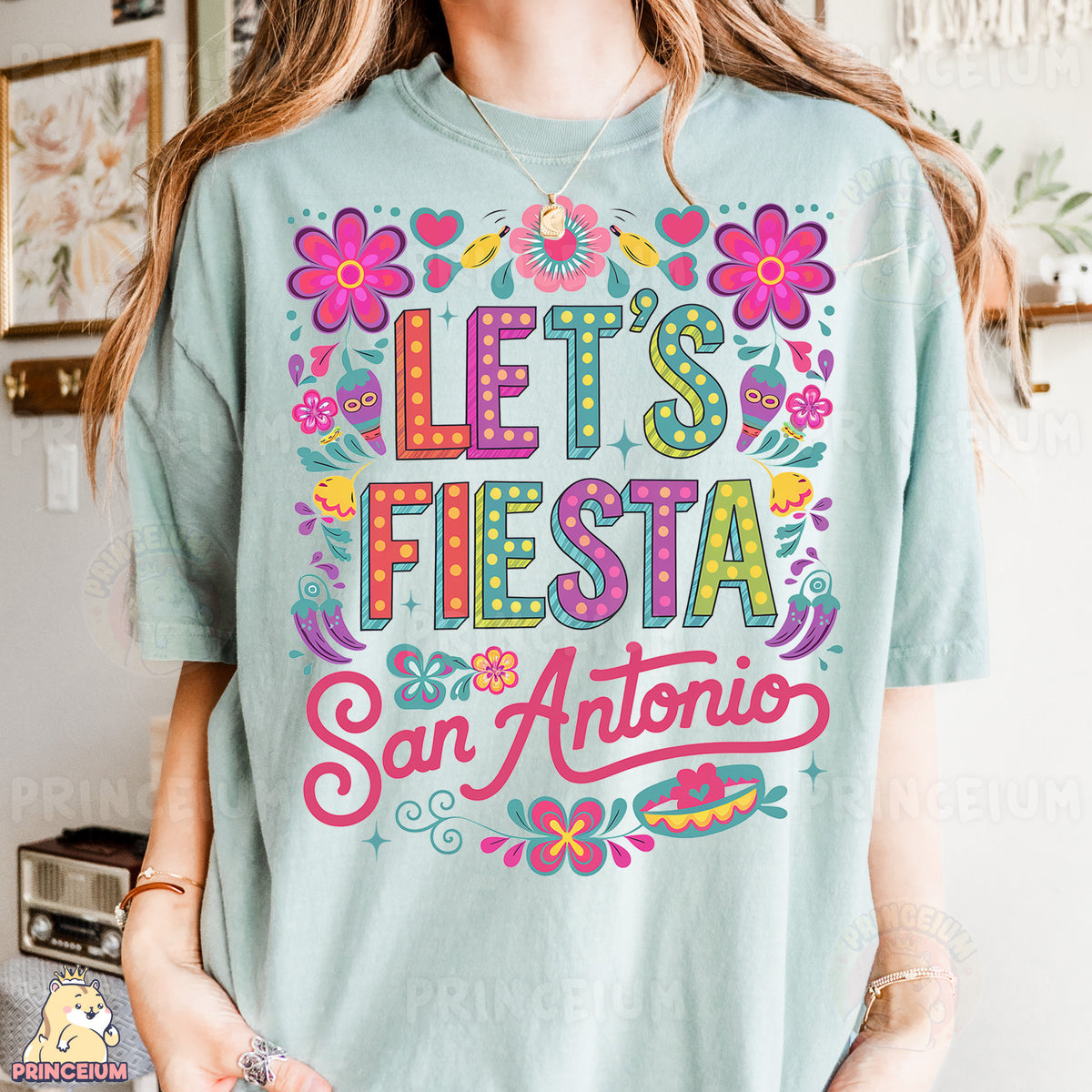 a woman wearing a t - shirt that says let's fiesta san antonio