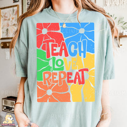 a woman wearing a t - shirt that says teach love repeat