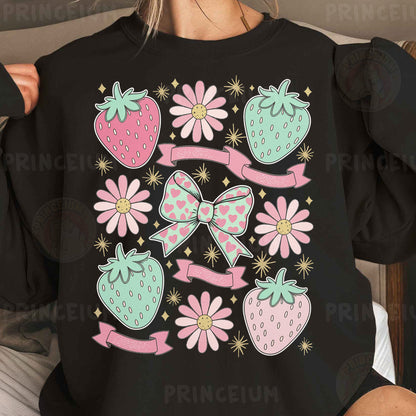 a woman wearing a black shirt with pink and green bows and strawberries on it