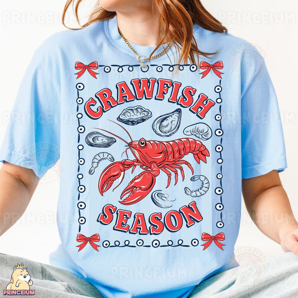 a woman wearing a blue shirt with a lobster on it