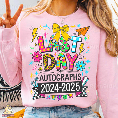 a woman wearing a pink shirt that says last day of autographs