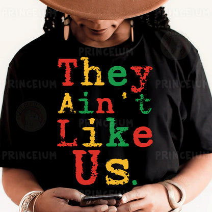 a person wearing a black shirt with the words they are like us on it