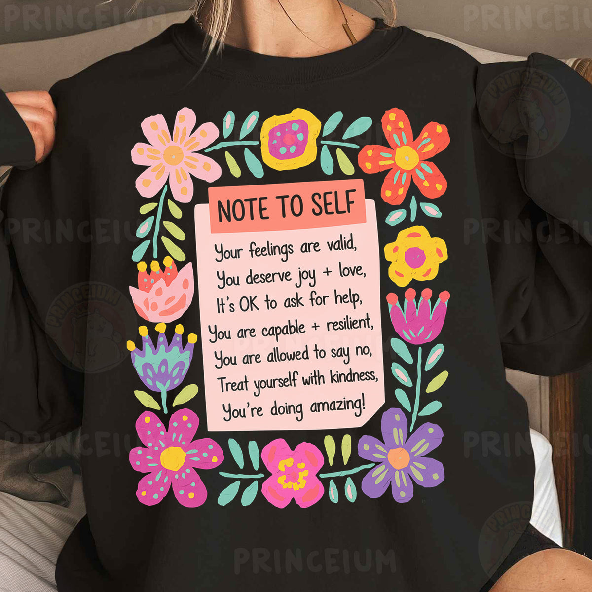 a woman wearing a black shirt with a note to self on it