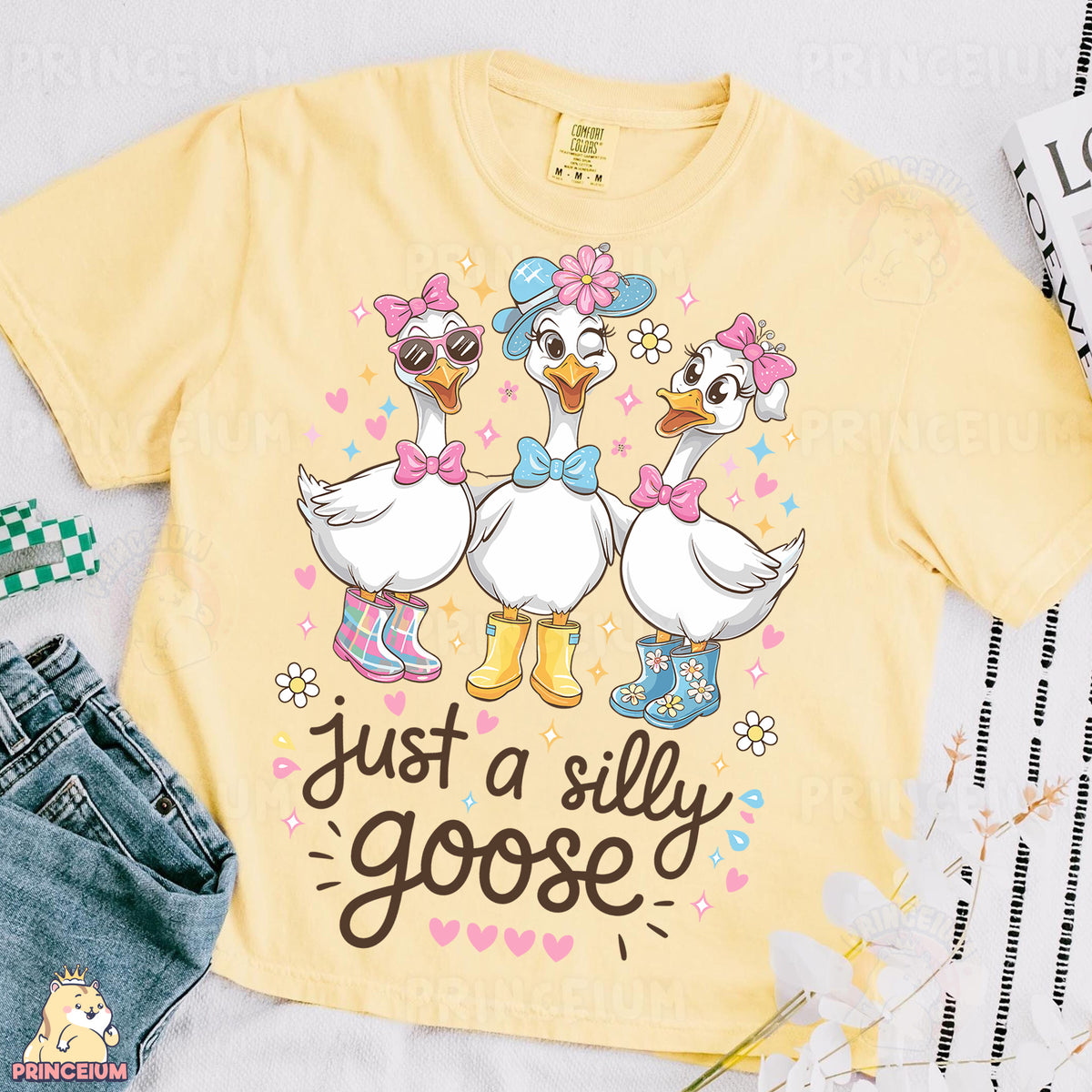 a yellow shirt with two ducks on it