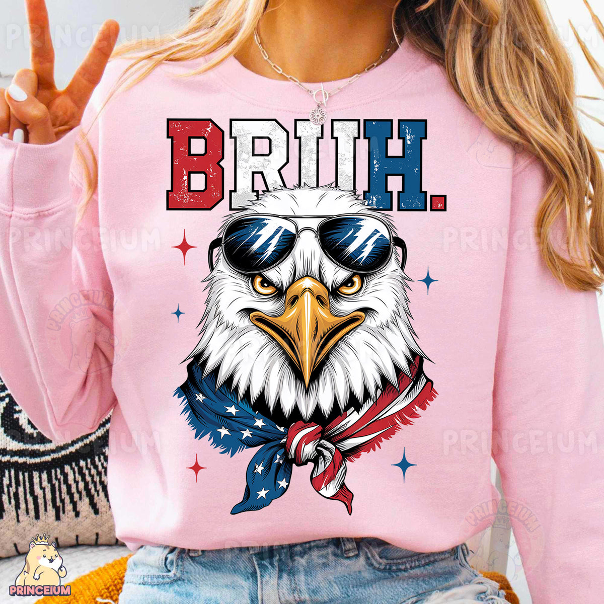 a woman wearing a pink sweatshirt with an eagle wearing sunglasses