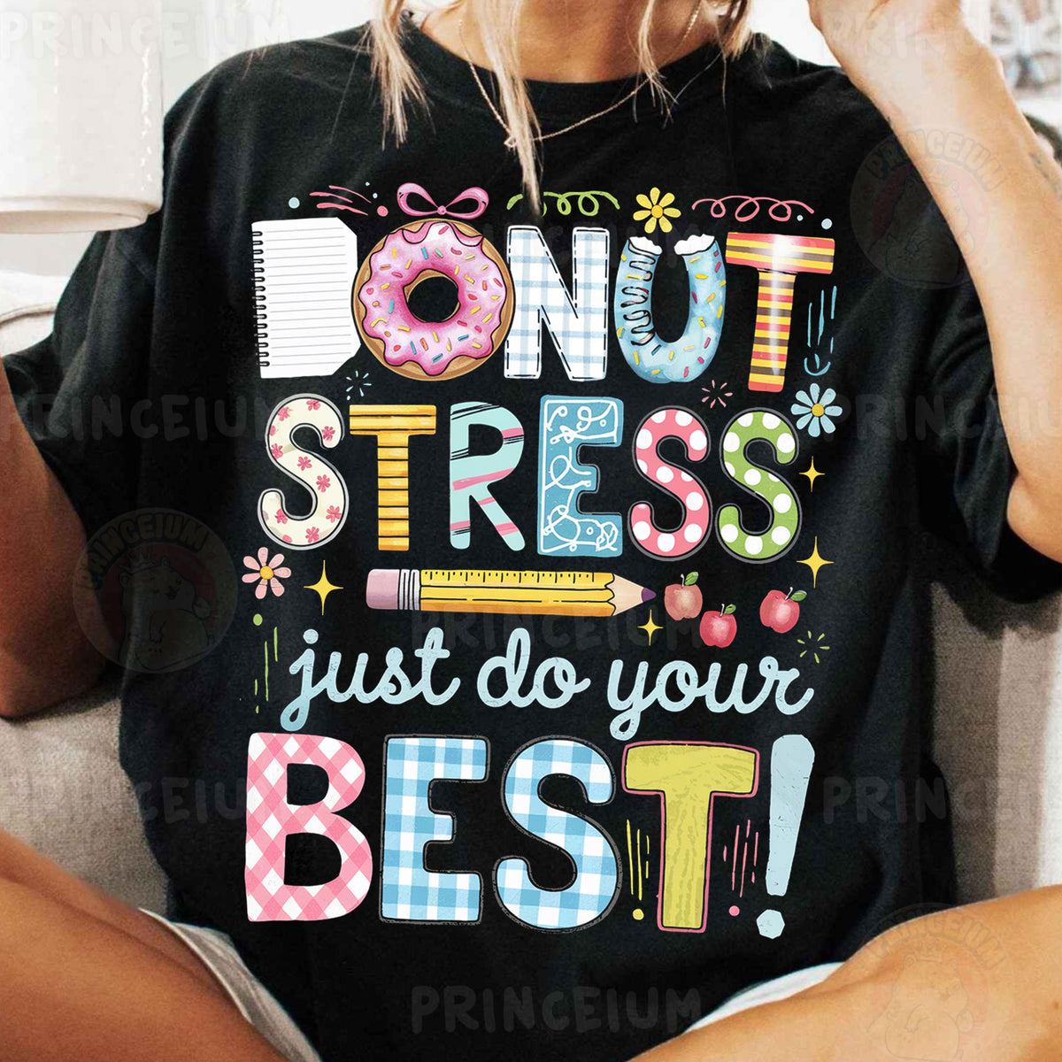 a woman sitting on a couch wearing a donut stress shirt