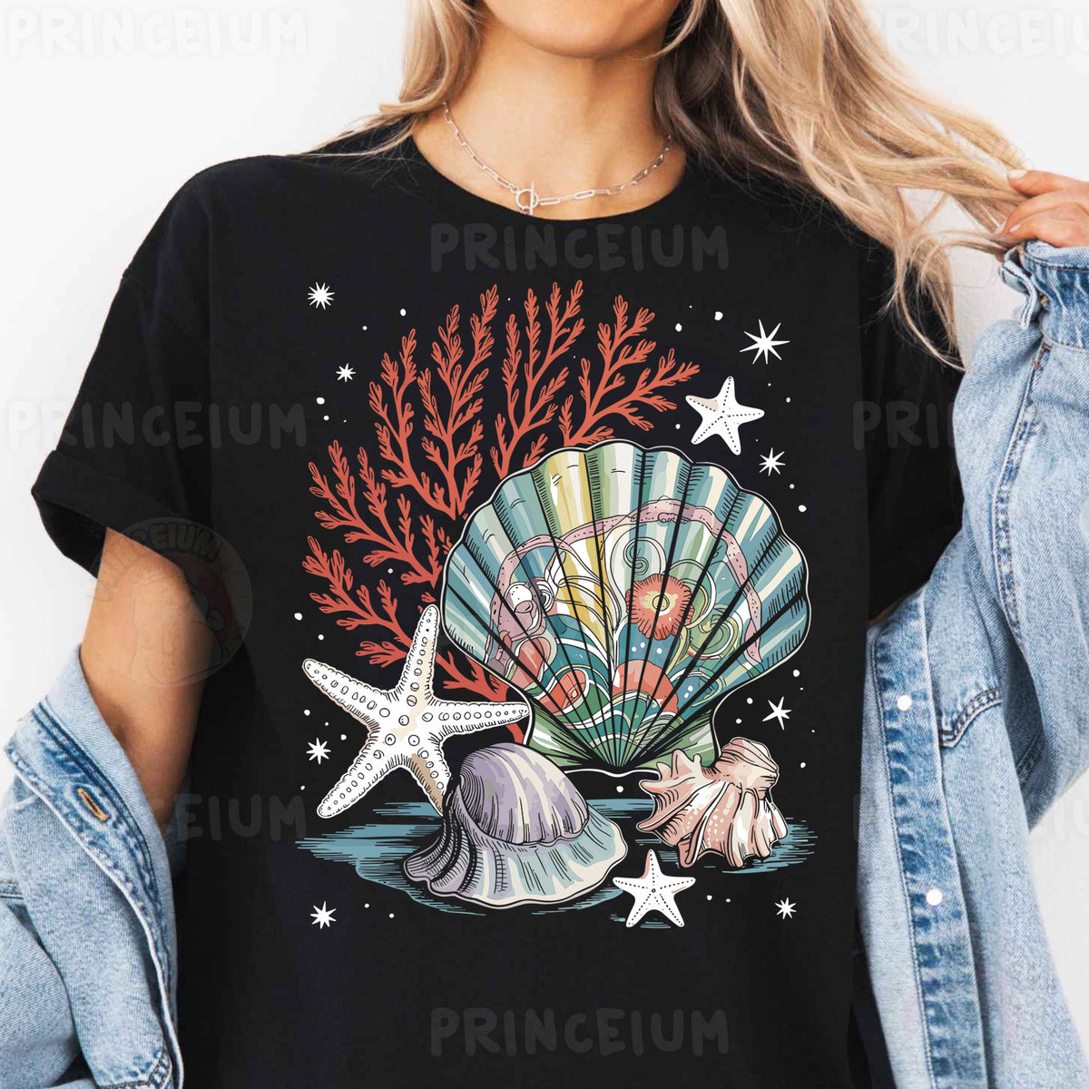 a woman wearing a black t - shirt with a seashell and starfish on