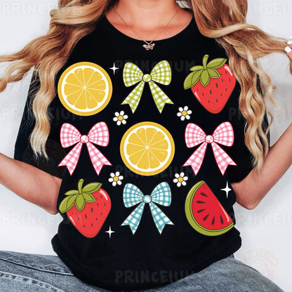 a woman wearing a black shirt with fruit and bows on it