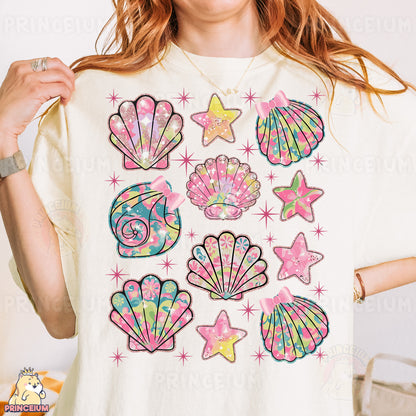 a woman wearing a t - shirt with a bunch of seashells on it