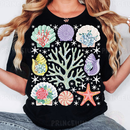 a woman wearing a black shirt with colorful seashells on it