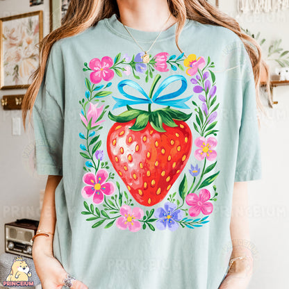 a woman wearing a t - shirt with a strawberry on it