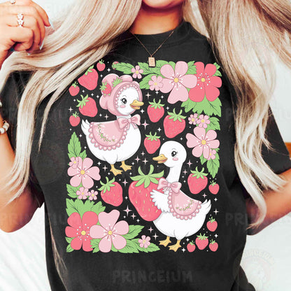 a woman wearing a black shirt with pink flowers and two ducks on it