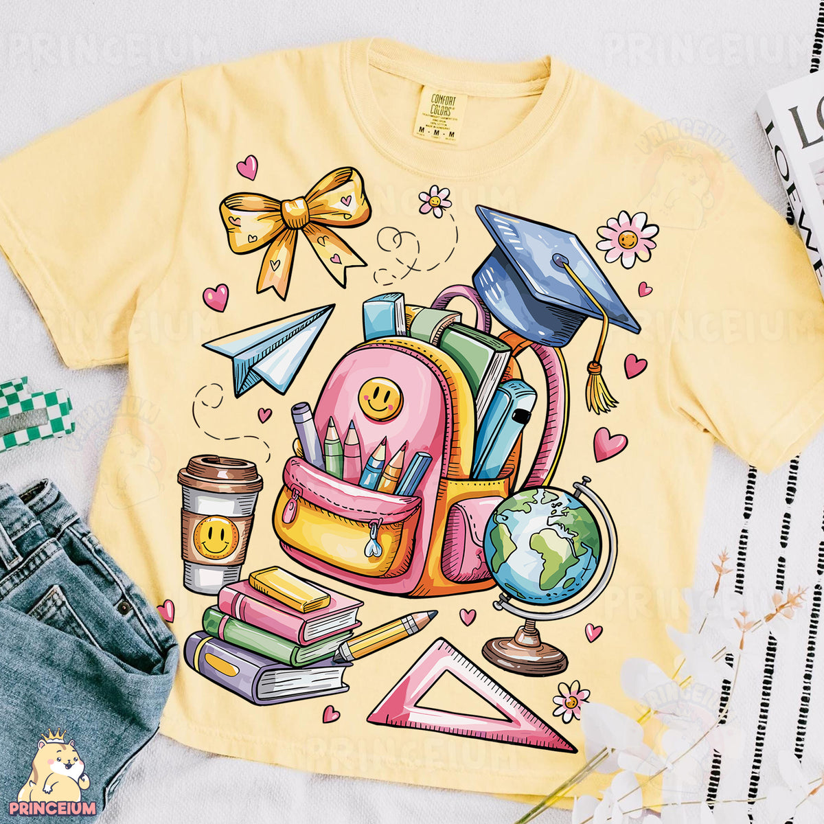 a yellow shirt with a picture of a backpack and books