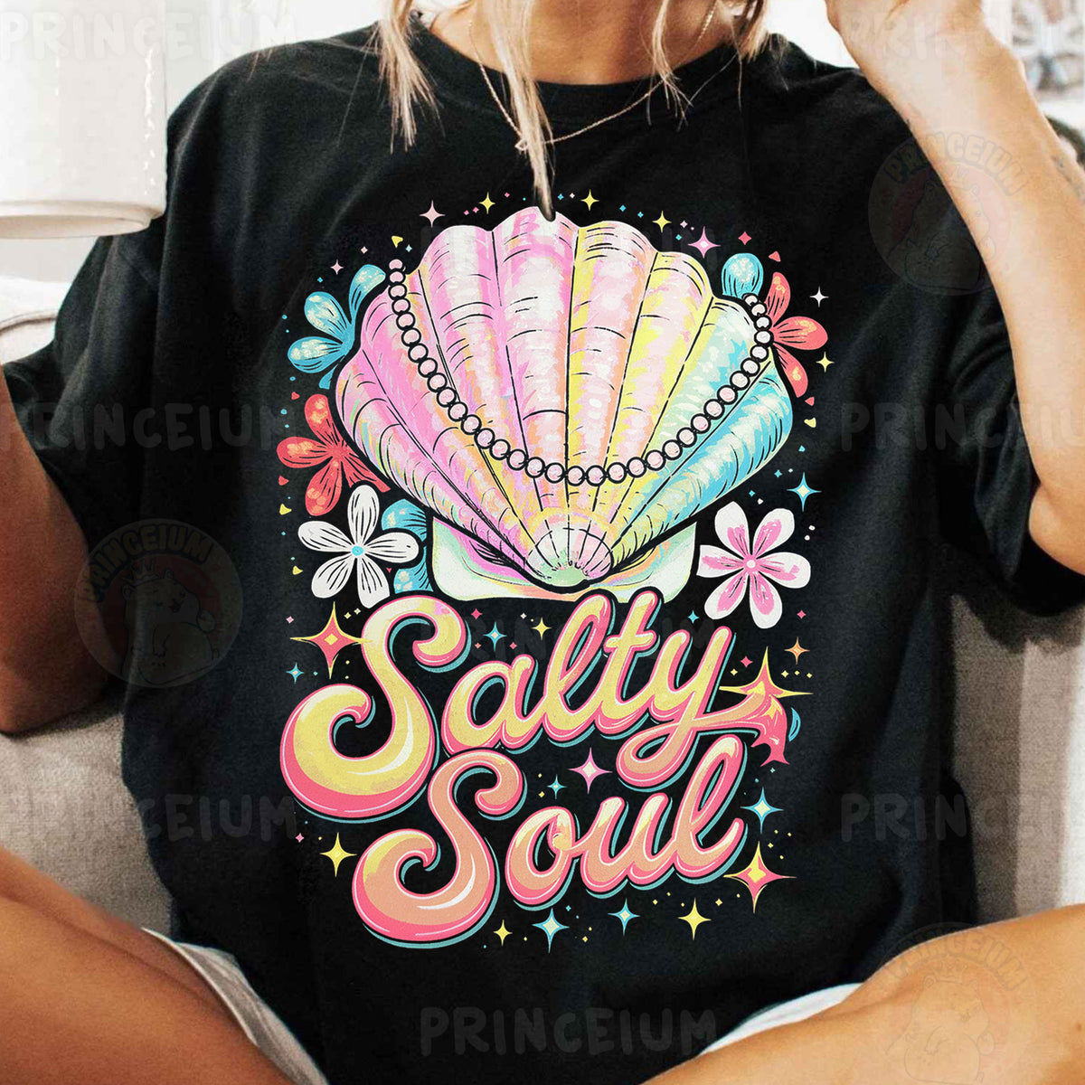 a woman sitting on a couch wearing a t - shirt that says salty soul