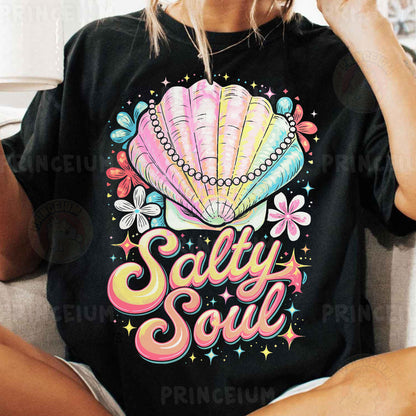 a woman sitting on a couch wearing a t - shirt that says salty soul