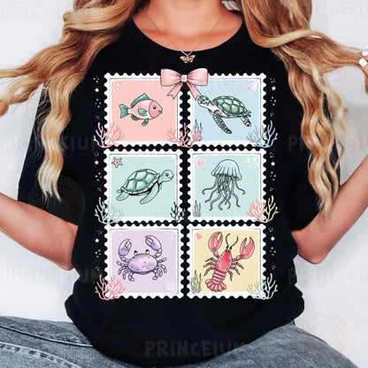a woman wearing a t - shirt with stamps on it