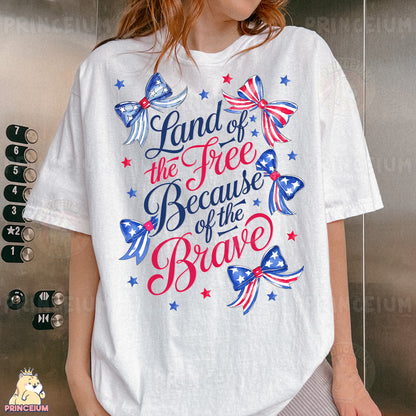 a woman wearing a white t - shirt that says land of the free because of