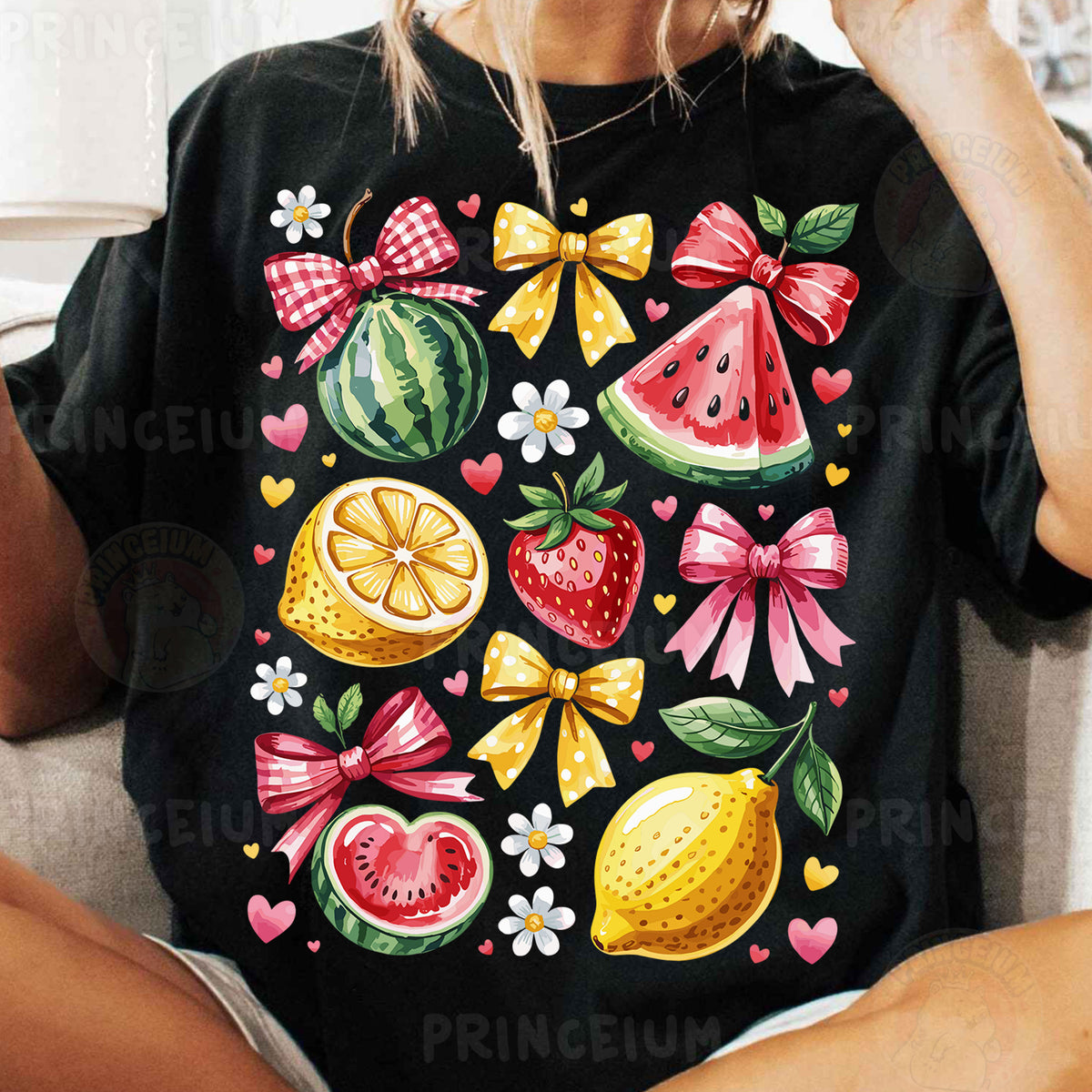 a woman sitting on a couch wearing a black shirt with fruit on it
