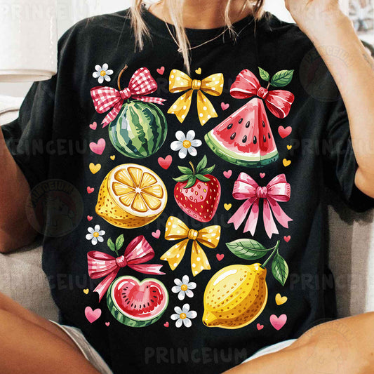 a woman sitting on a couch wearing a black shirt with fruit on it