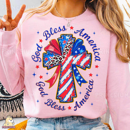 a woman wearing a pink shirt with a cross on it