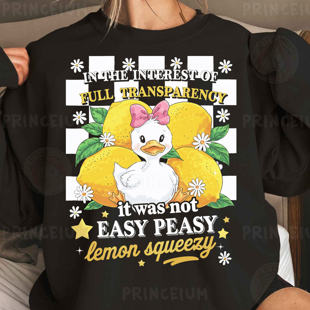 a woman wearing a black t - shirt with an image of a duck on it