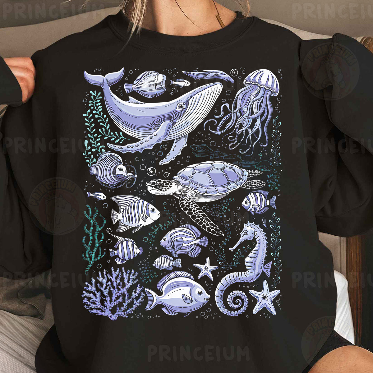 a woman wearing a black shirt with a picture of sea animals on it