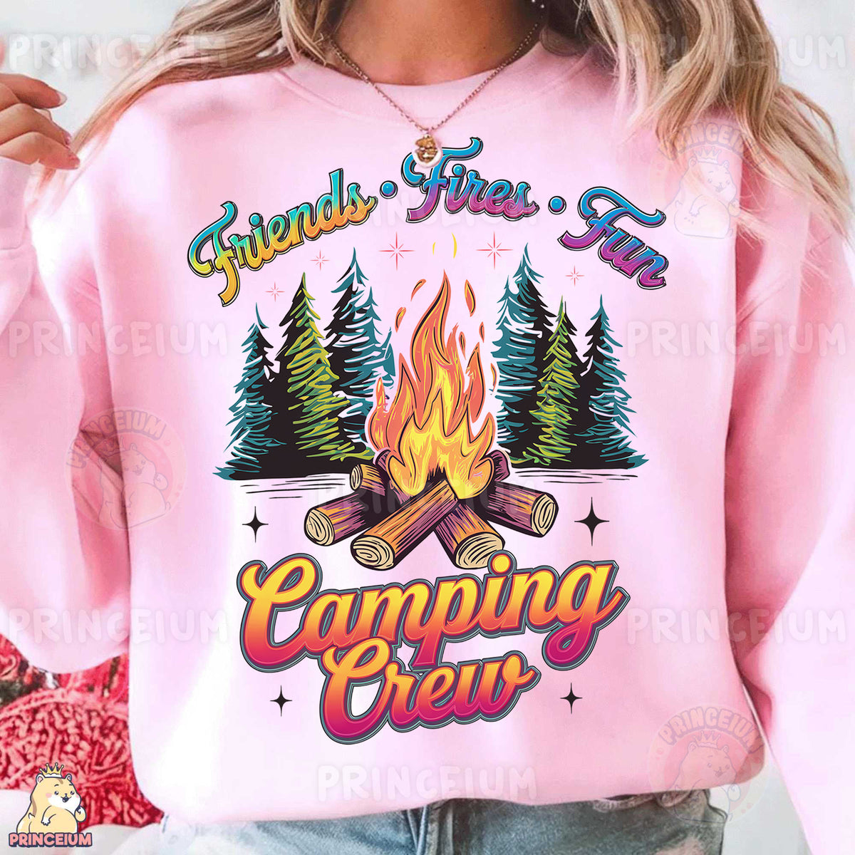 a woman wearing a pink sweatshirt with a campfire on it