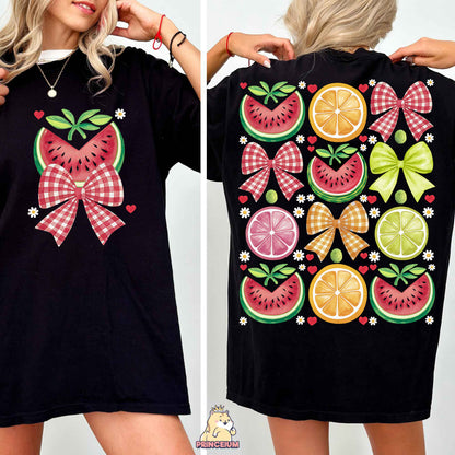 a woman wearing a black shirt with fruit on it