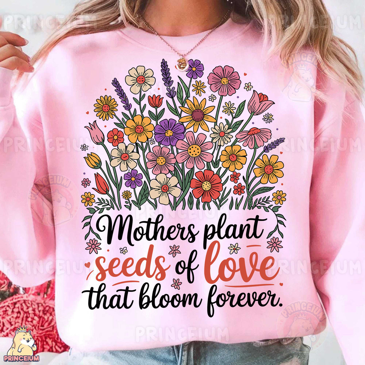 a woman wearing a pink sweatshirt that says mothers plant seeds of love that bloom forever