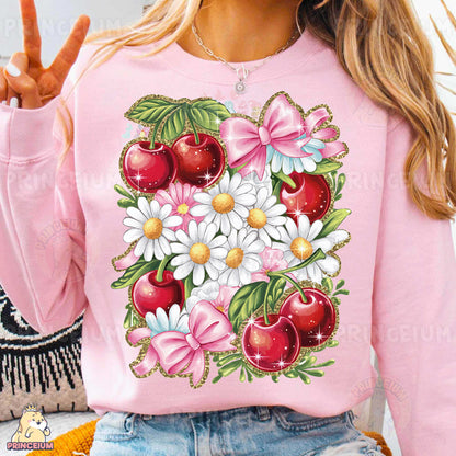 a woman wearing a pink sweatshirt with flowers and apples on it