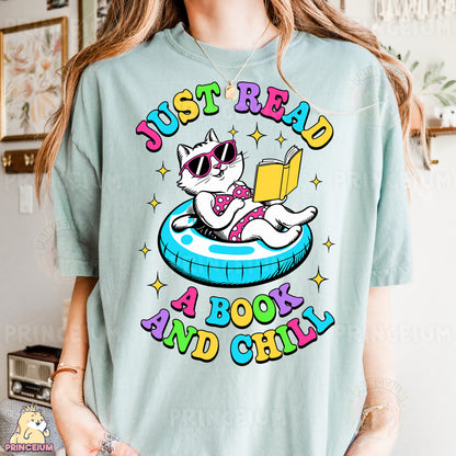 a woman wearing a t - shirt with a cat reading a book