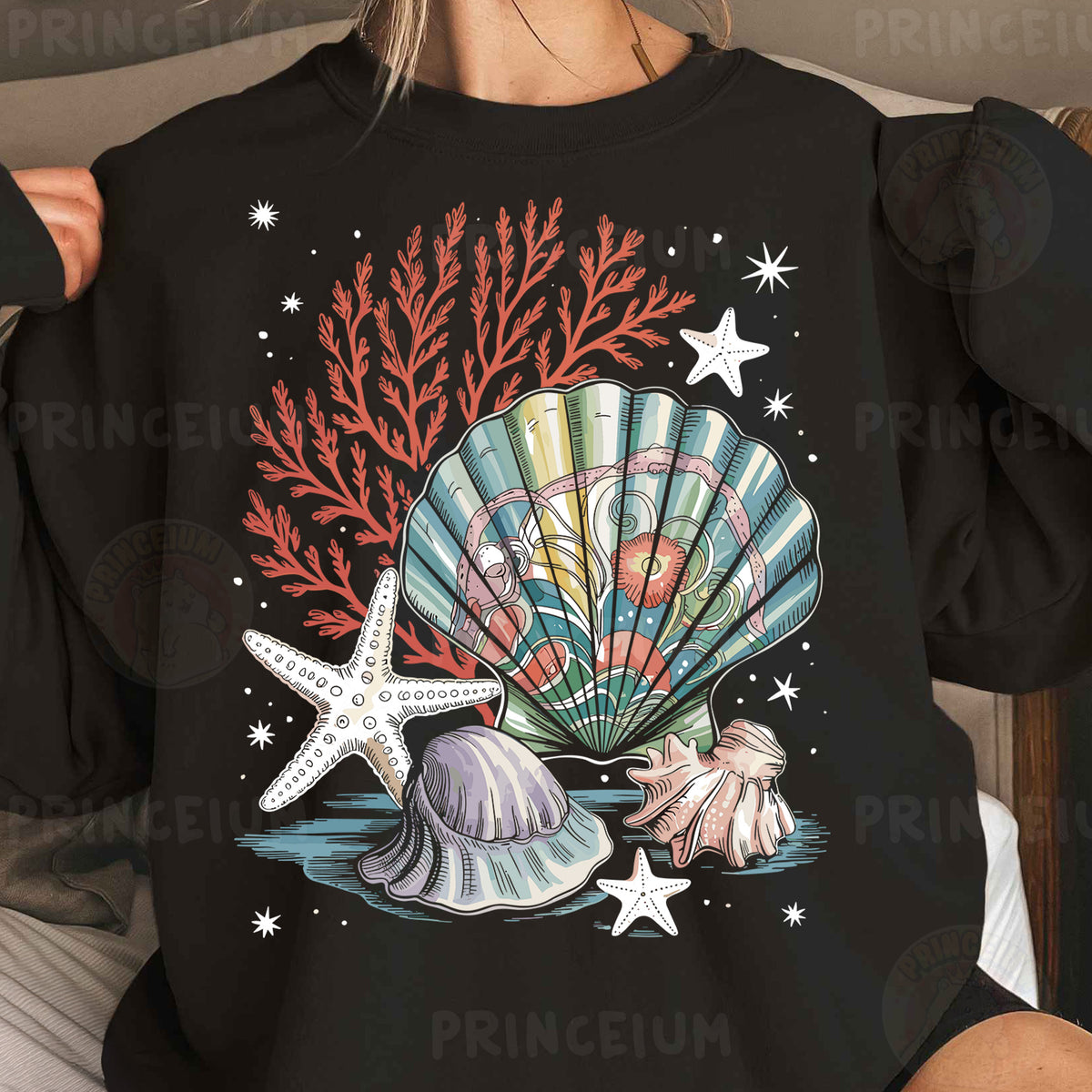 a woman wearing a black shirt with a seashell and starfish on it