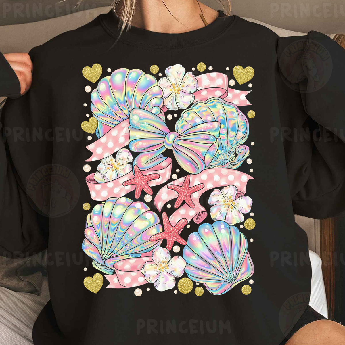 a woman wearing a black sweatshirt with pink bows and seashells on it