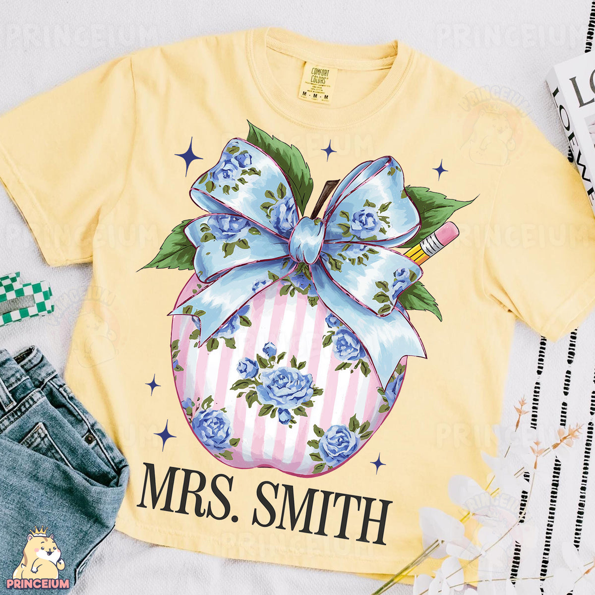a yellow shirt with a blue bow on it