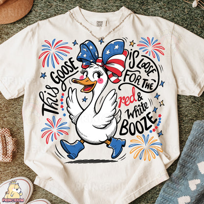 a white t - shirt with a cartoon duck wearing a red, white, and