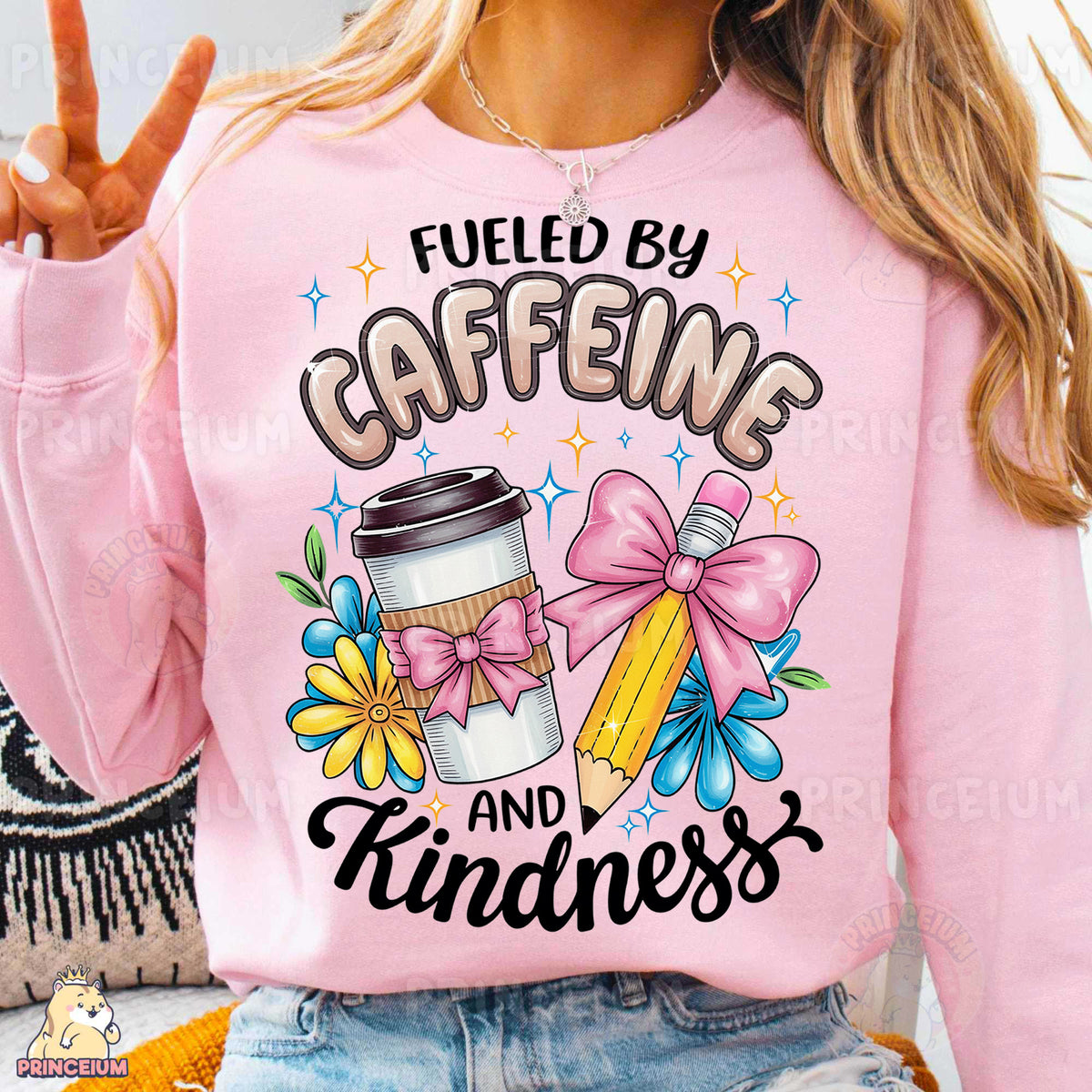 a woman wearing a pink sweatshirt that says fueled by caffeine and princess