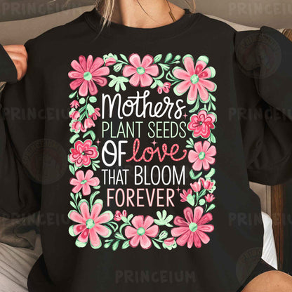 a woman wearing a black shirt that says mothers plant seeds of love that bloom forever