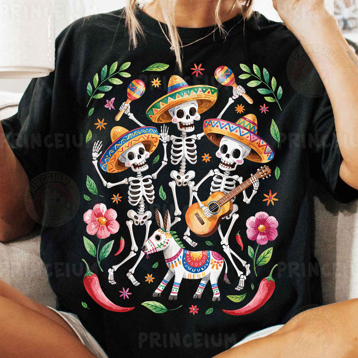 a woman sitting on a couch wearing a mexican skeleton t - shirt