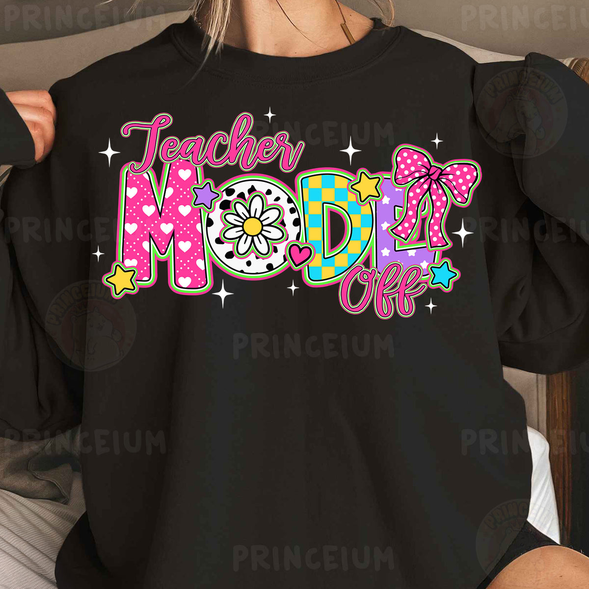 a woman wearing a black teacher mom shirt