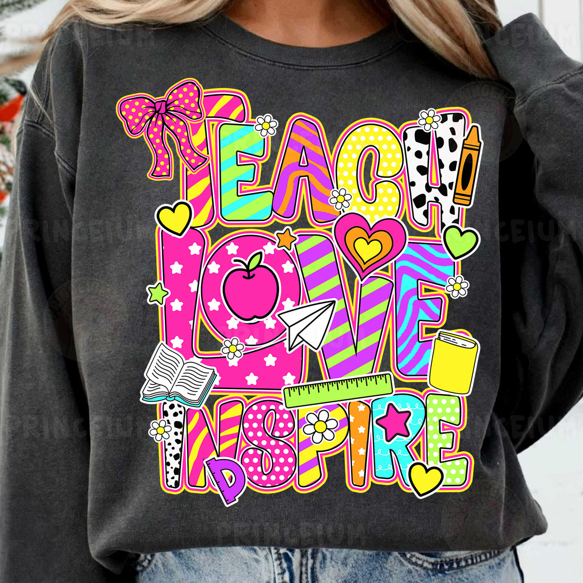 a woman wearing a sweatshirt that says peace love inspire