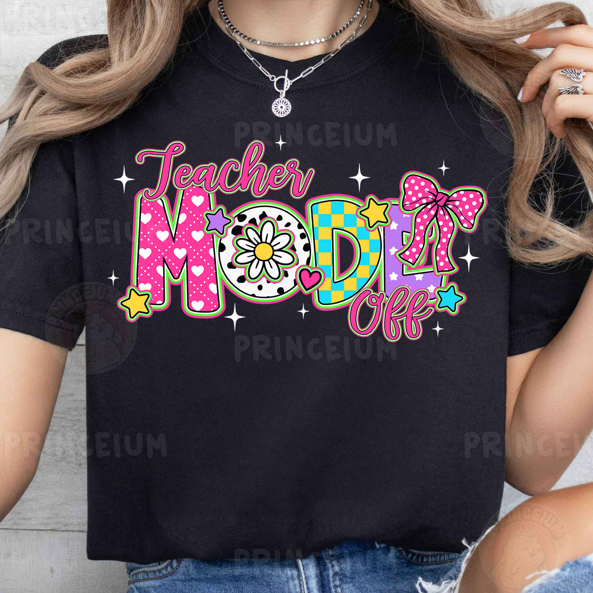 a woman wearing a black teacher mom shirt