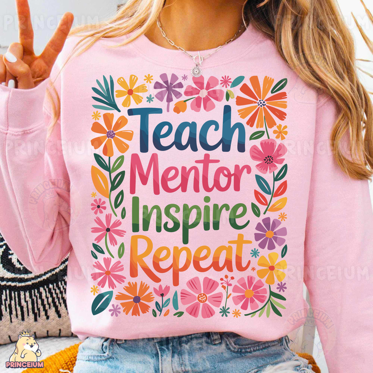 a woman wearing a pink sweatshirt that says teach mentor inspire repeat