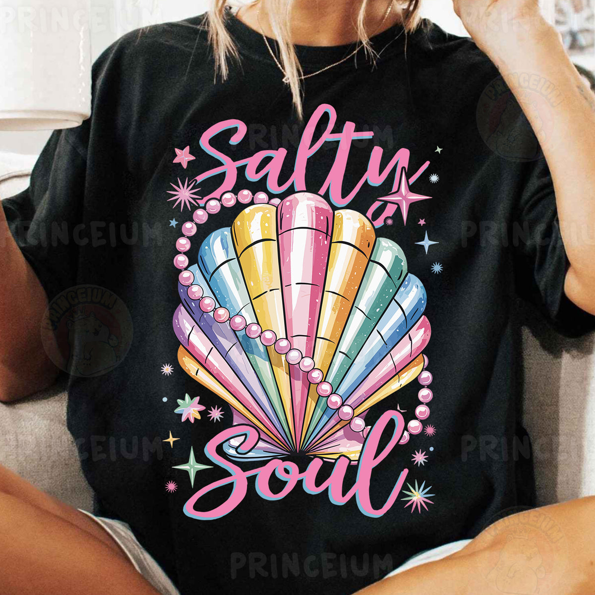 a woman sitting on a couch wearing a shirt that says salty soul