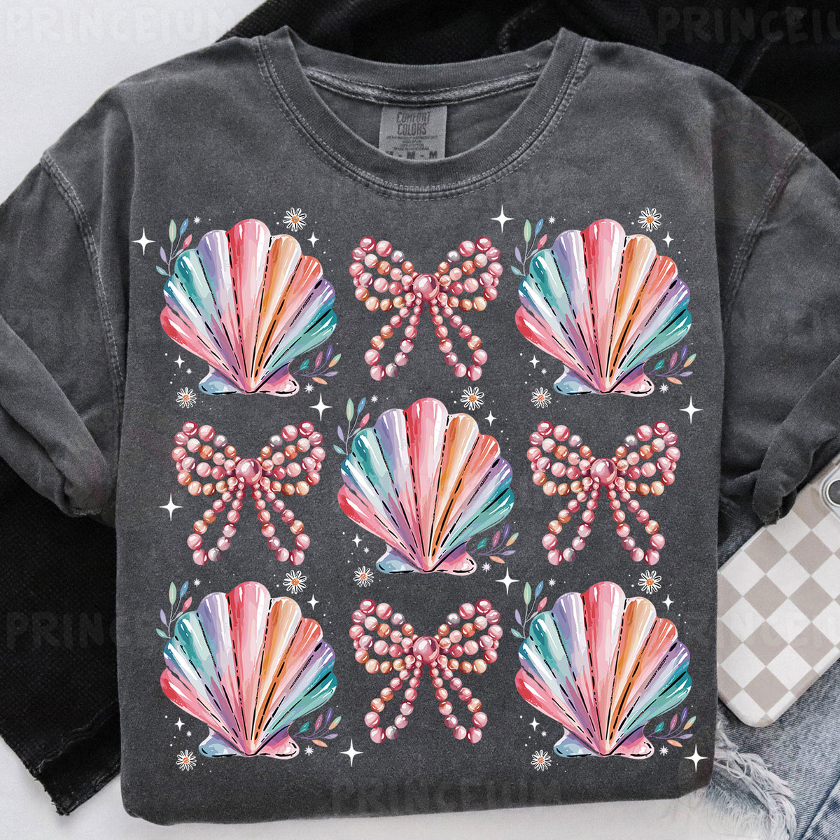 a t - shirt that has a bunch of seashells on it
